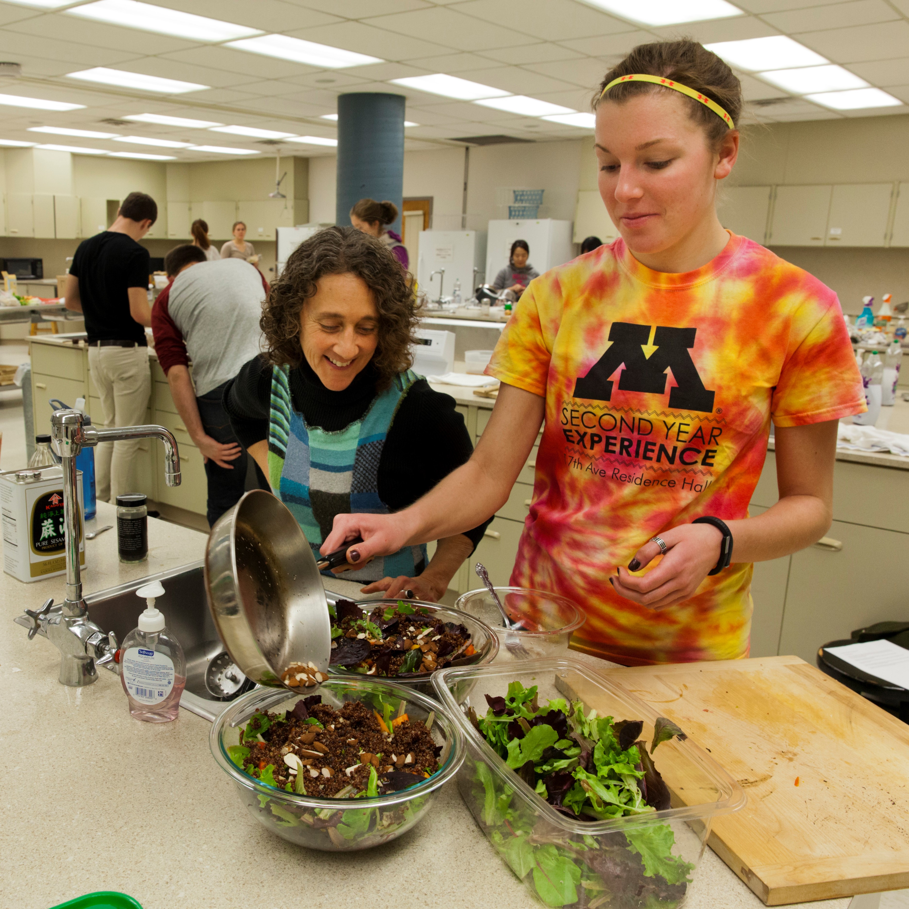 student and instructor making salads