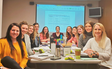 Dietetic Interns seated around table posing for picture